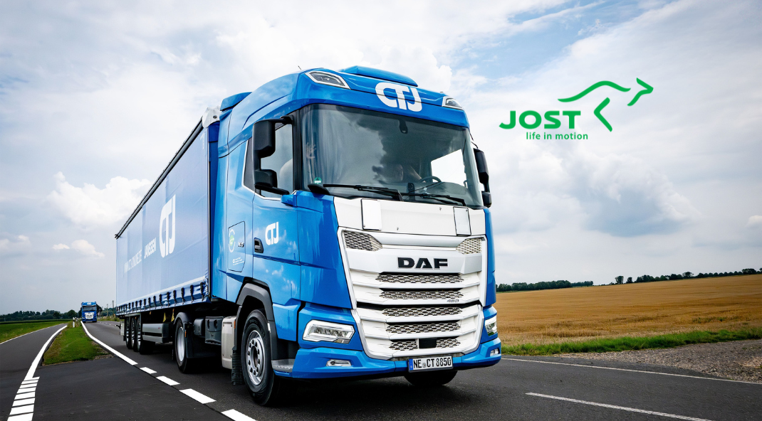 Blue CTJ Transport semi-trailer truck driving on a country road, with the JOST Life in Motion logo in the background.
