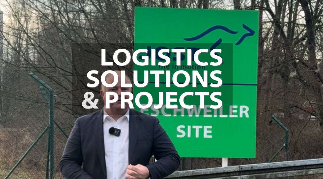 a man is presenting in front of a green JOST sign indicating the Eschweiler site, with the Logistics Solutions & Projects logo.