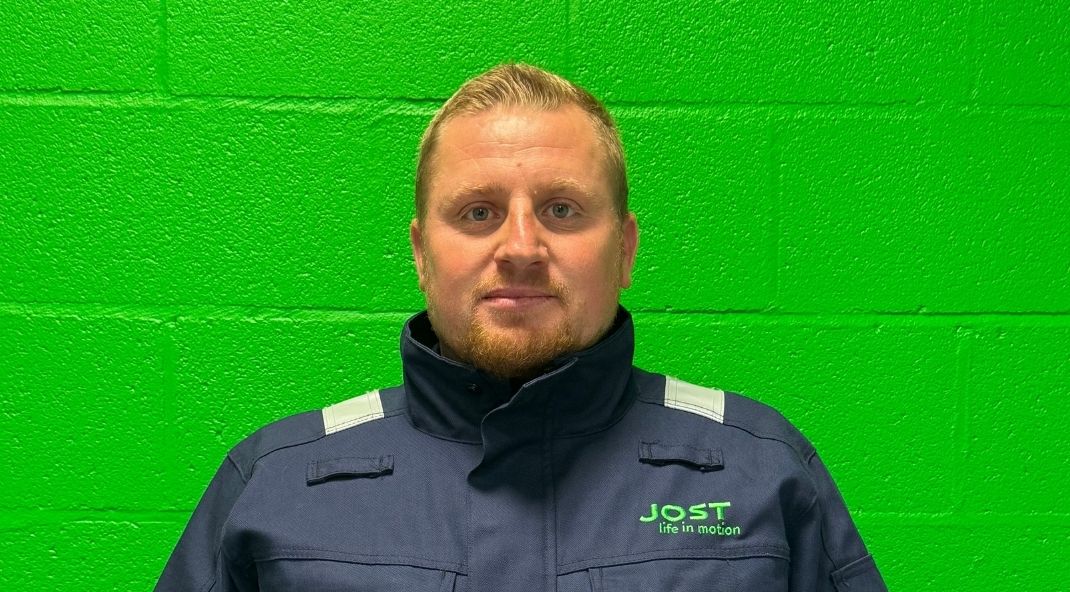 A man in a navy work uniform with the 